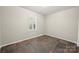 Bedroom featuring earth tone flooring, modern window with shutters, and neutral paint at 3000 Low Gap Rd, Waxhaw, NC 28173