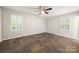 Bedroom featuring modern ceiling fan, earth tone flooring, and window shutters at 3000 Low Gap Rd, Waxhaw, NC 28173