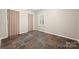 Bedroom with earth tone flooring, built-in storage, and window shutter at 3000 Low Gap Rd, Waxhaw, NC 28173