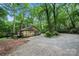 View of the house's side featuring a cozy deck in a private, wooded lot with mature trees and long driveway at 3000 Low Gap Rd, Waxhaw, NC 28173