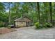 View of the house's side featuring a cozy deck in a private, wooded lot with mature trees at 3000 Low Gap Rd, Waxhaw, NC 28173