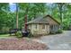 View of the house's side featuring a cozy deck in a private, wooded lot with mature trees at 3000 Low Gap Rd, Waxhaw, NC 28173