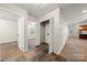 Hallway featuring tiled floor, closet with bi-fold doors, doorways, and white walls at 3000 Low Gap Rd, Waxhaw, NC 28173