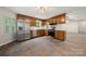 Kitchen featuring stainless steel appliances, window, wood cabinets, and tiled floor at 3000 Low Gap Rd, Waxhaw, NC 28173