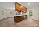 Bright kitchen featuring custom wood cabinetry, stainless steel appliances and tiled floor at 3000 Low Gap Rd, Waxhaw, NC 28173