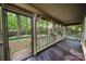 Screened porch with stained wood flooring and view of wooded area at 3000 Low Gap Rd, Waxhaw, NC 28173
