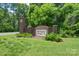 Welcoming brick neighborhood entrance sign surrounded by lush greenery at 3178 Newcastle Dr # 42, Rock Hill, SC 29732