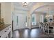 Entryway with hardwood floors leading to dining area and a white front door at 3178 Newcastle Dr # 42, Rock Hill, SC 29732