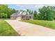 A large brick home with an attached garage and a long driveway leading up to the property at 3178 Newcastle Dr # 42, Rock Hill, SC 29732