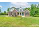 Charming brick two-story home with a vibrant blue door and manicured front yard landscaping at 3178 Newcastle Dr # 42, Rock Hill, SC 29732