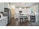 Bright kitchen featuring white cabinets, stainless steel appliances, a large island, and hardwood floors at 3178 Newcastle Dr # 42, Rock Hill, SC 29732