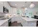 Open-concept kitchen with white cabinets, a center island, stainless steel appliances and hardwood floors at 3178 Newcastle Dr # 42, Rock Hill, SC 29732