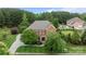 Stunning aerial view of a brick home showcasing lush landscaping and a sprawling yard at 3206 Lakehurst Xing, Matthews, NC 28104