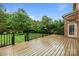 Spacious wooden back deck overlooking a lush, well-maintained backyard with mature trees at 3206 Lakehurst Xing, Matthews, NC 28104