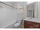 Bright bathroom with a tub/shower combo, vanity with modern fixtures, and ample natural light at 3206 Lakehurst Xing, Matthews, NC 28104