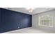 Cozy bedroom featuring a navy accent wall and a bright window for natural light at 3206 Lakehurst Xing, Matthews, NC 28104