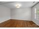 Bright bedroom with hardwood floors, a ceiling fan, and a large window for natural light at 3206 Lakehurst Xing, Matthews, NC 28104