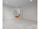 Spacious bonus room with neutral carpet and double doors leading to other rooms at 3206 Lakehurst Xing, Matthews, NC 28104