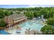 Aerial view of a large community pool featuring a waterslide and lounge chairs at 3206 Lakehurst Xing, Matthews, NC 28104