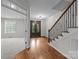 Inviting foyer with hardwood floors, staircase, and a decorative glass front door welcomes you home at 3206 Lakehurst Xing, Matthews, NC 28104