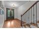 Bright foyer with hardwood floors, a staircase, and a decorative front door at 3206 Lakehurst Xing, Matthews, NC 28104
