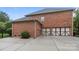 Brick home featuring a spacious concrete driveway leading to a two-car garage at 3206 Lakehurst Xing, Matthews, NC 28104