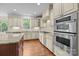 Bright kitchen featuring white cabinets, stainless steel appliances and granite countertops at 3206 Lakehurst Xing, Matthews, NC 28104