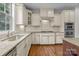Bright kitchen featuring white cabinets, stainless steel appliances, granite countertops, and hardwood floors at 3206 Lakehurst Xing, Matthews, NC 28104