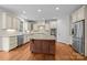 Bright kitchen featuring white cabinets, stainless steel appliances, granite countertops, and a wood island at 3206 Lakehurst Xing, Matthews, NC 28104