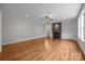 Open living room boasts hardwood floors, a fireplace, and built-in shelves at 3206 Lakehurst Xing, Matthews, NC 28104