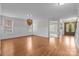 Spacious living room with hardwood floors, wainscoting, and ample natural light at 3206 Lakehurst Xing, Matthews, NC 28104