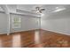 Large main bedroom features a tray ceiling, hardwood floors, and two bright windows at 3206 Lakehurst Xing, Matthews, NC 28104