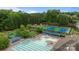 Aerial view of a community pool, lounge chairs, and several tennis courts at 3206 Lakehurst Xing, Matthews, NC 28104
