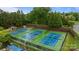 Aerial view of several community tennis courts surrounded by lush trees at 3206 Lakehurst Xing, Matthews, NC 28104