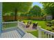 Inviting backyard featuring a stone fire pit, outdoor seating, manicured lawn, and mature trees for shade and privacy at 331 Solomon St, Charlotte, NC 28216