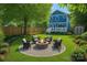Backyard with outdoor seating area, fire pit, and lush landscaping surrounding the perimeter at 331 Solomon St, Charlotte, NC 28216