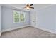 This cozy bedroom is painted light blue and has a ceiling fan and closet at 331 Solomon St, Charlotte, NC 28216