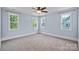 Spacious bedroom with three windows, light blue walls, and a ceiling fan at 331 Solomon St, Charlotte, NC 28216