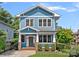 Charming two-story blue home featuring a welcoming front porch, well-manicured lawn, and classic architectural details at 331 Solomon St, Charlotte, NC 28216