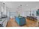 Open-concept kitchen features a large island, stainless steel appliances, and hardwood floors at 331 Solomon St, Charlotte, NC 28216