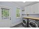 Laundry room with modern washer and dryer, ample storage, and lots of light at 331 Solomon St, Charlotte, NC 28216