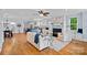Open-concept living room with hardwood floors, fireplace, and seamless flow to the kitchen at 331 Solomon St, Charlotte, NC 28216