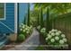 Landscaped side yard with elegant stone path and manicured hydrangeas adding appeal at 331 Solomon St, Charlotte, NC 28216