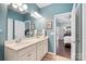 This lovely bathroom has a double vanity, tile floors, and leads to the main bedroom at 344 Linestowe Dr, Belmont, NC 28012