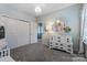 This bedroom features an ornate white dresser, chandelier, and a view into another room at 344 Linestowe Dr, Belmont, NC 28012