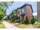 Well-maintained brick townhouse with lush landscaping, a walkway, and modern design elements at 344 Linestowe Dr, Belmont, NC 28012
