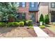 Inviting brick townhouse showcasing manicured landscaping, a charming entryway, and a well-kept lawn at 344 Linestowe Dr, Belmont, NC 28012