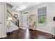 Welcoming foyer with hardwood floors, staircase, natural light, and a convenient hall tree at 344 Linestowe Dr, Belmont, NC 28012