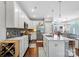 Bright kitchen with white cabinetry, stainless steel appliances, and large island with sink and counter seating at 344 Linestowe Dr, Belmont, NC 28012