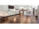 Open-concept living area with hardwood flooring, modern furnishings, and a seamless flow to the kitchen at 344 Linestowe Dr, Belmont, NC 28012